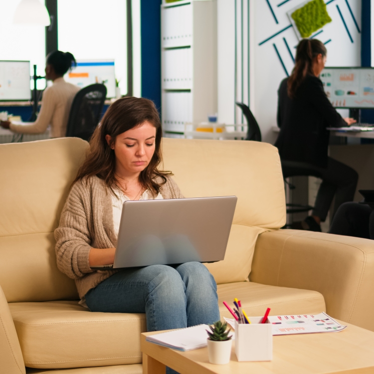 People sitting at desk with laptops working