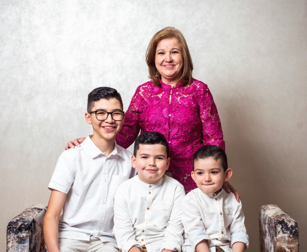 a woman and two boys are posing for a picture