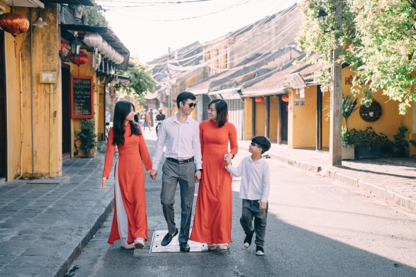 A group of people walking down a street