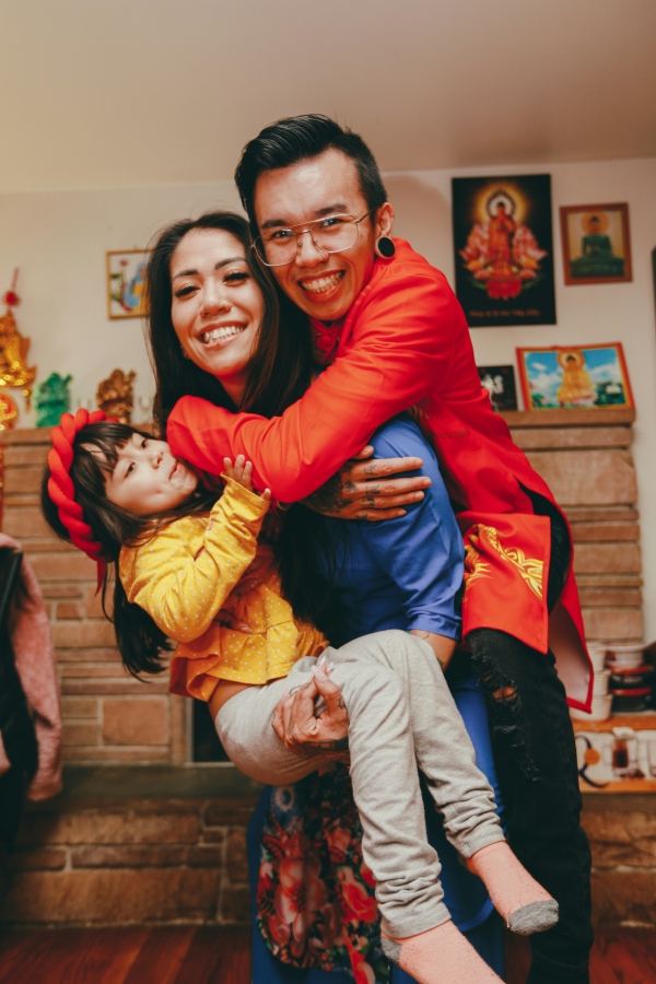 Woman and man holding baby