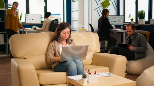 People sitting at desk with laptops working